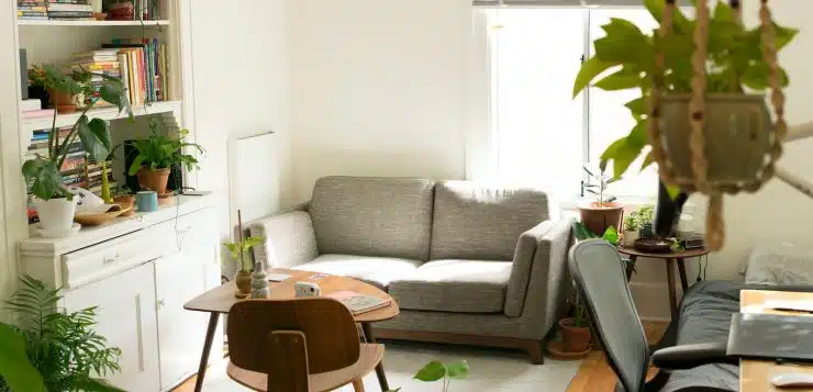 gray fabric loveseat near brown wooden table